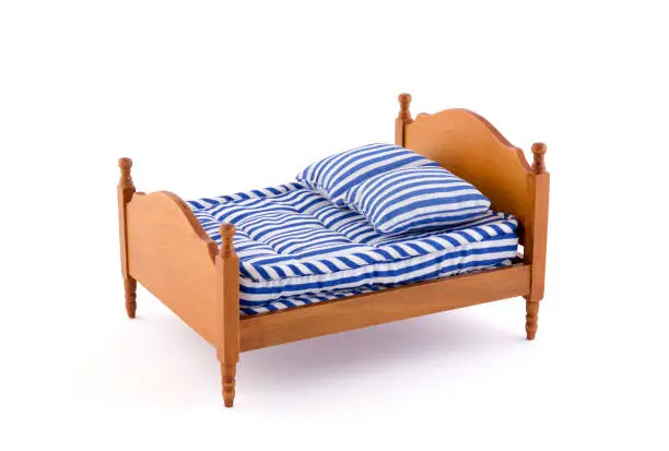 Wooden bed miniature on white background with clipping path