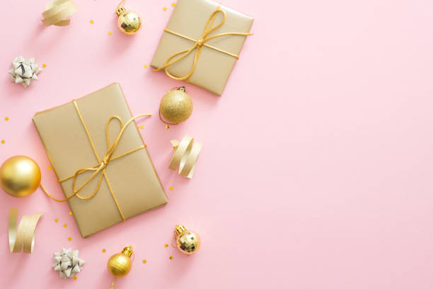 istock Christmas composition. Christmas golden decorations, gift boxes, baubles, confetti on pastel pink background with copy space. Flat lay, top view. Greeting card mockup. Christmas celebration concept. 1172269691