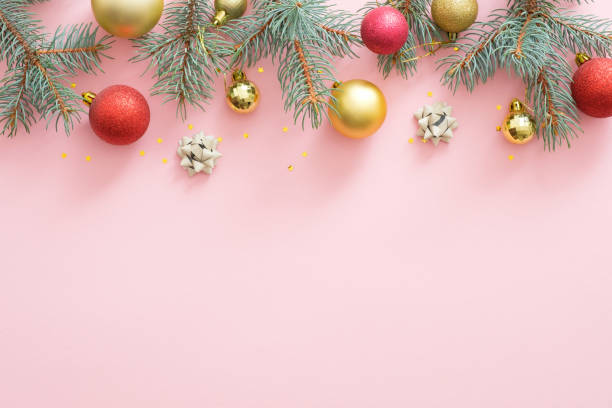 istock Christmas frame made of bright glittering baubles, fir tree branches, decorations on pink pastel background. Christmas party invitation card mockup, postcard template. Flat lay, top view, overhead 1172269757