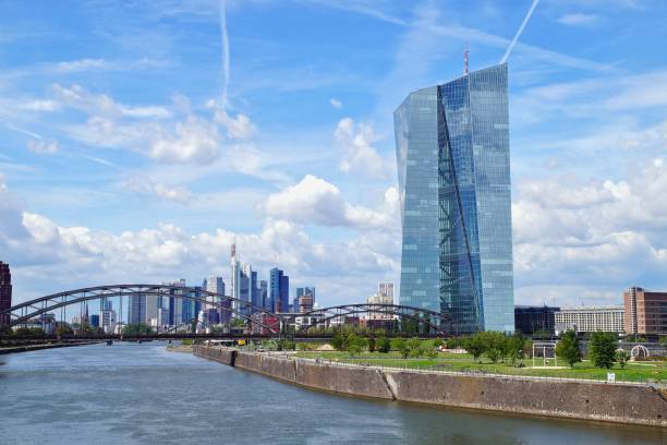 view of the river Main with the headquarters of ECB and the skyline of Frankfurt in background. European Central Bank and Skyscraper buildings in Germany with blue sky background. stock photo