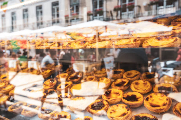 portuguese pastries in lisbon behind bakery window with reflection of the city
