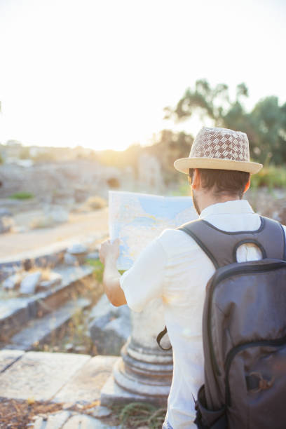 istock Tourist with a map exploring Ephesus at sunset 1172273327
