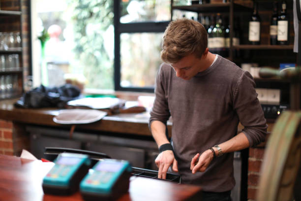 istock a Restaurant manager using the cash register. 1172275275