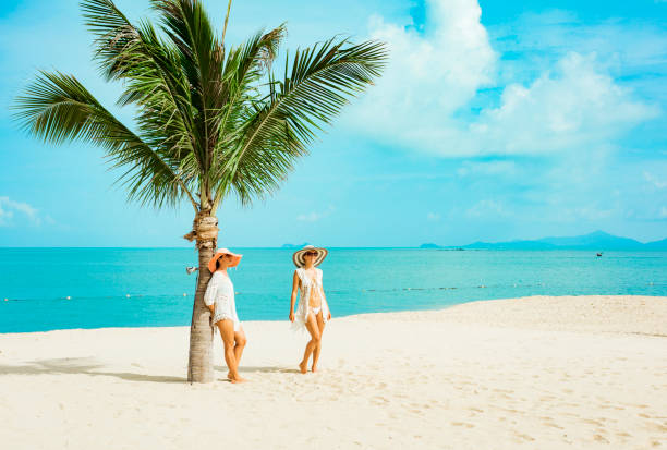 istock Cuople woman at tropical beach 1172279259