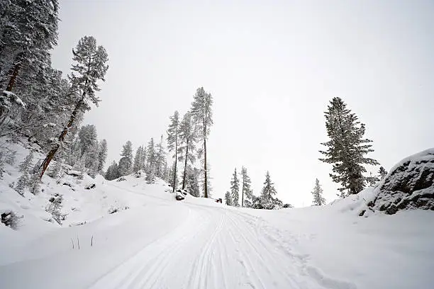 A way leading up a mountain with snow. Wide angle view.