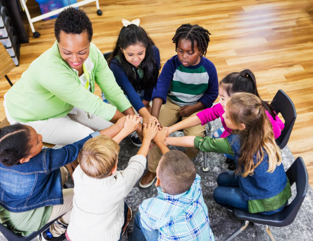 istock Elementary school teacher and children work together 1172283185