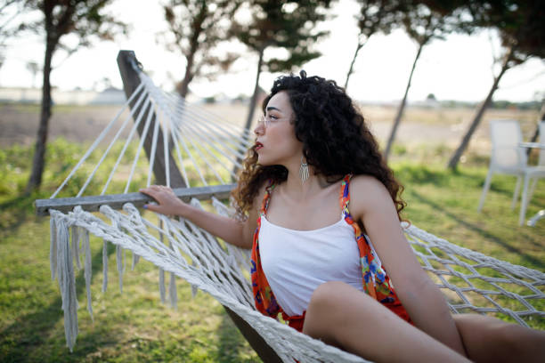 istock Young woman laying in hammock 1172284579