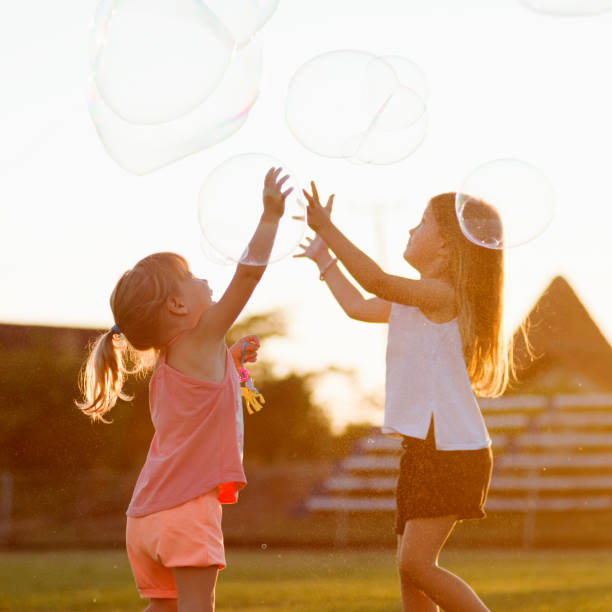istock girls playing with soap bubbles 1172285416