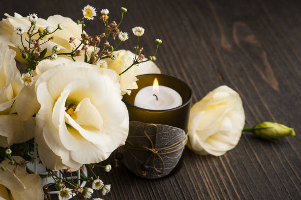 istock Yellow lisianthus flowers and lit candle 1172285654