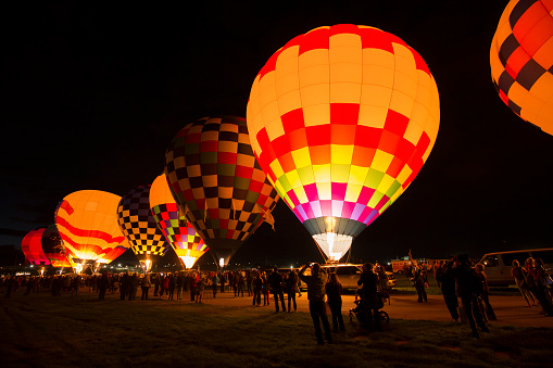 Albuquerque, New Mexico - USA - Oct 7, 2023: Gas balloons preparing to launch after sunset for the 66th Coupe Aeronautique Gordon Bennett balloon race at the Albuquerque International Balloon Fiesta.