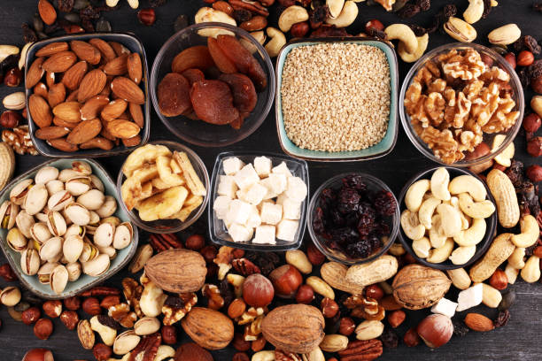 istock Composition with dried fruits and assorted healthy nuts on rustic background 1172289340