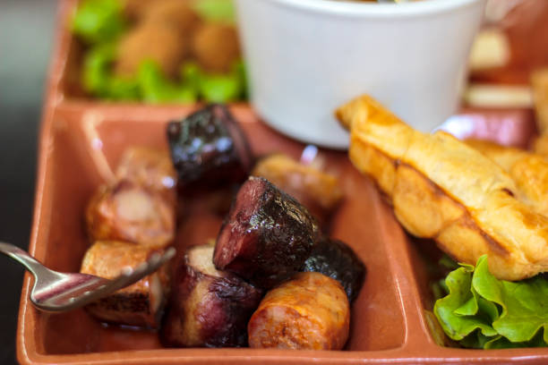 A plate with meat and French fries and wine in restaurant
