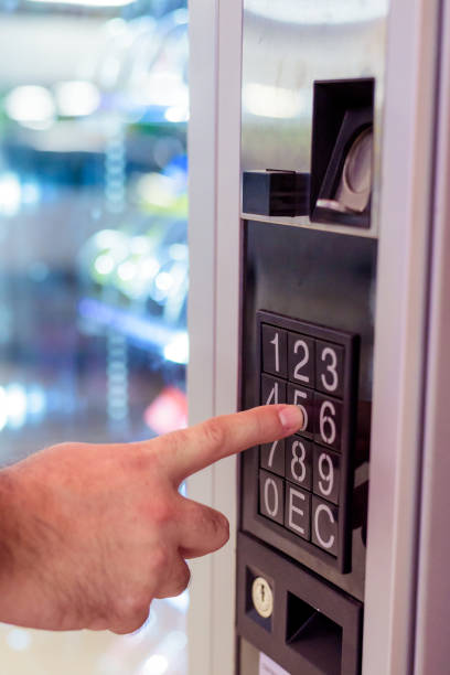 istock sell, technology and consumption concept - hand pushing button on vending machine operation panel keyboard 1172291055