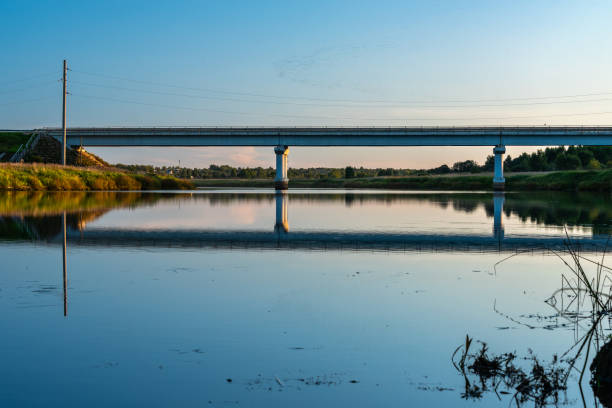 istock Rural landscape with road bridge, river at sunset 1172291090