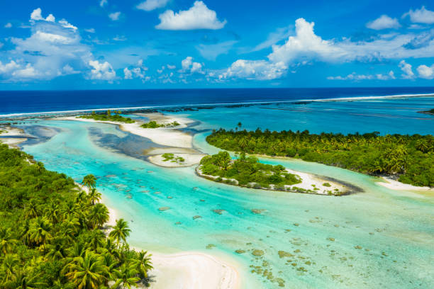 Rangiroa aerial image of atoll island reef motu in French Polynesia Tahiti Rangiroa aerial drone video of atoll island motu and coral reef in French Polynesia, Tahiti. Amazing nature landscape with blue lagoon and Pacific Ocean. Tropical island paradise in Tuamotus Islands. polynesia photos stock pictures, royalty-free photos & images