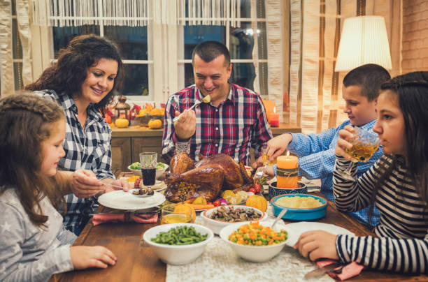 istock Family having traditional thanksgiving dinner at home 1172292334