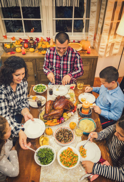 istock Family having traditional thanksgiving dinner at home 1172292472