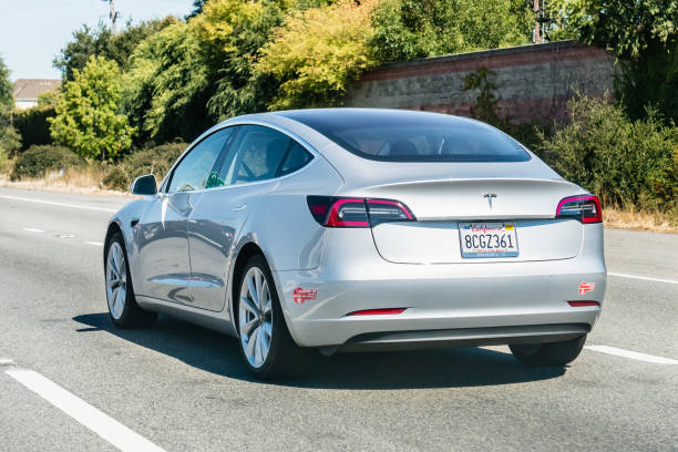 Tesla Model 3 driving on the freeway August 31, 2019 Mountain View / CA / USA - Tesla Model 3 driving on the freeway tesla model 3 stock pictures, royalty-free photos & images