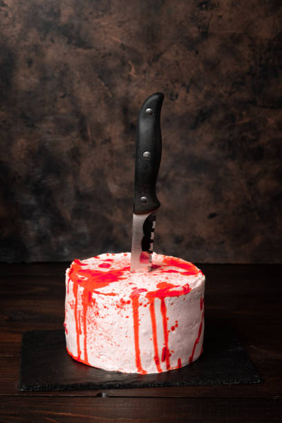 istock Bleeding monster cake with a knife on dark background 1172293167