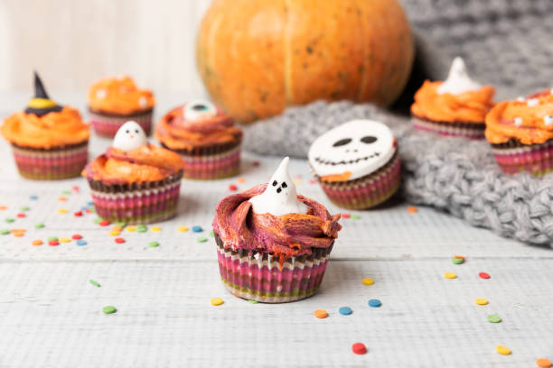 istock Halloween cupcakes decorated colored decorations witch hat, orange cream 1172293238