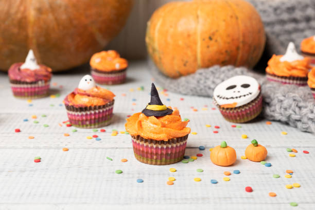 istock Halloween cupcakes decorated colored decorations witch hat, orange cream 1172293280