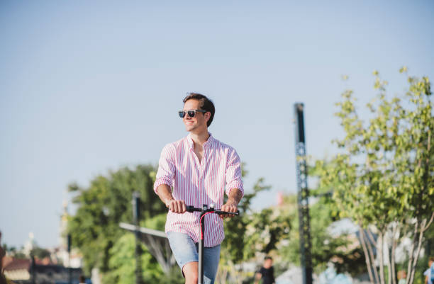 istock Young man on electric scooter during sunny day 1172293408