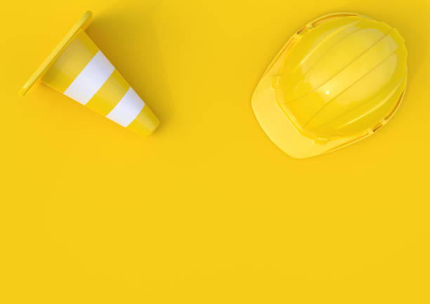 istock Under construction, traffic cones and safety helmet, isolated on bright yellow background 1172297223