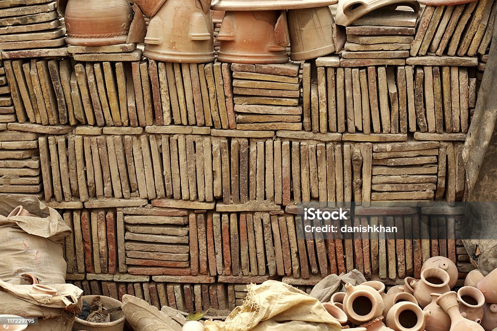 Earthenware Wall made from clay tiles and other pottery. Arrangement Stock Photo