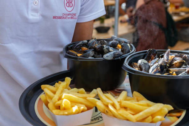 Traditional dish on Lille Braderie, mussels and fries (moules frites). Lille,FRANCE-September 01,2019: Great Lille Braderie (Braderie de Lille). Traditional dish on Lille Braderie, mussels and fries. moules frites stock pictures, royalty-free photos & images