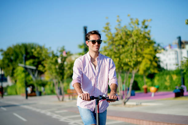 istock Young man on electric scooter during sunny day 1172298184