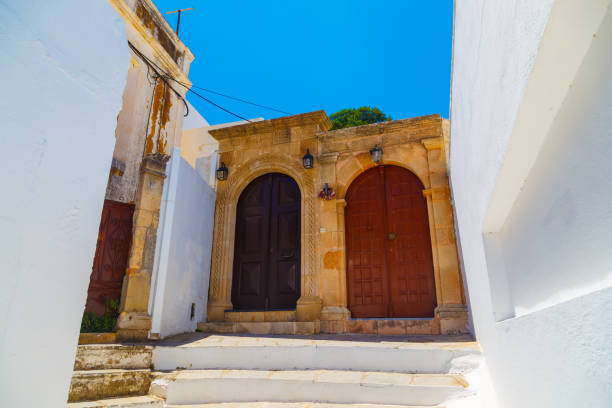 istock Ancient Greek architecture with traditional doors and decorative pavement in Lindos town, Rhodes island, Greece. 1172298965