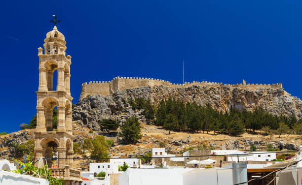 Tower of Church of Panagia in Lindos made of ancient stones Tower of Church of Panagia in the Lindos made of ancient stones ayia kyriaki chrysopolitissa stock pictures, royalty-free photos & images