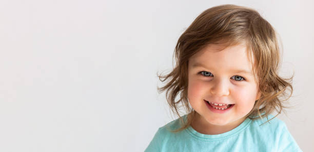 beautiful happy toddler child girl smiling, portrait neutral background - shirt lifestyles close up cheerful imagens e fotografias de stock