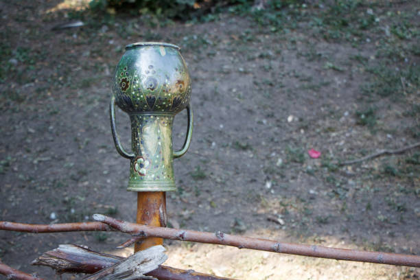 istock A metal jug with two handles hanging on a fence post, selective focus 1172304048
