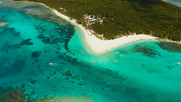 istock Tropical Daco Island with a sandy beach and tourists 1172304222