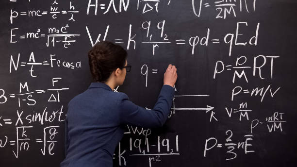 istock Female tutor writing formula on chalkboard, mathematics lecture, exact sciences 1172312636