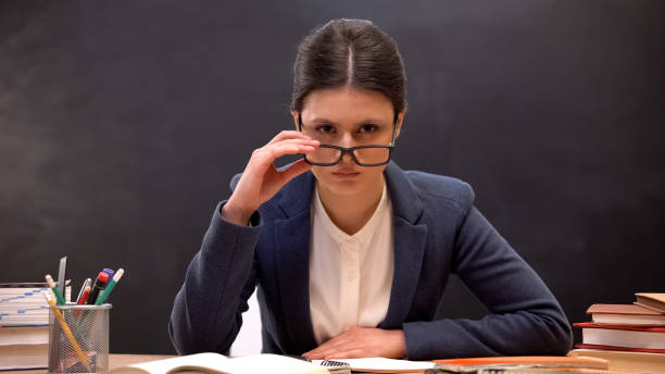 istock Angry teacher looking aggressively to camera taking off glasses, strict lecturer 1172312768