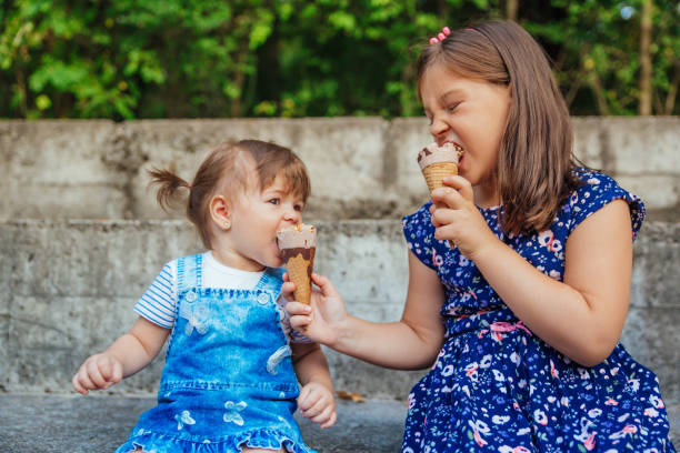 istock Girls enjoying eating ice cream. 1172312827