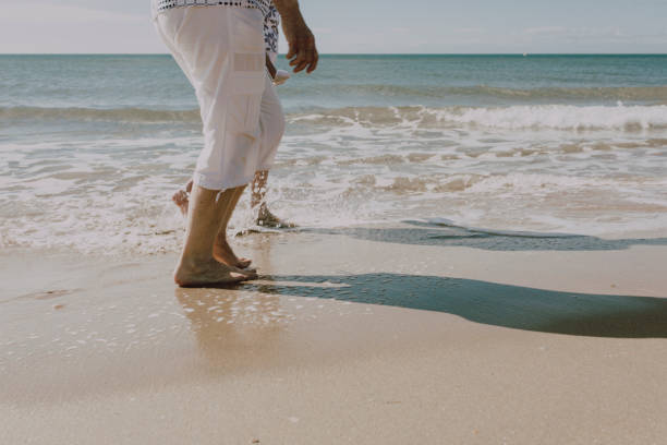 istock Retirement people taking a walk on the beach 1172315193