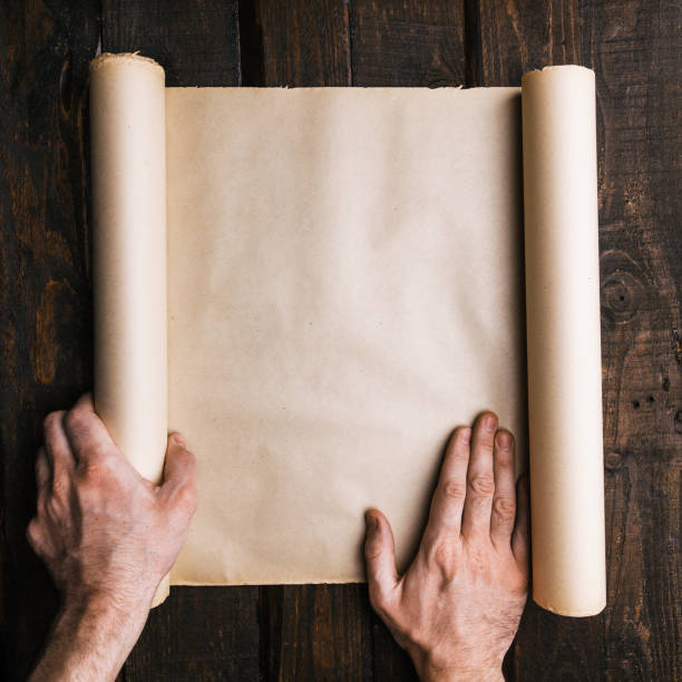istock Male hands hold ancient paper roll 1172317309