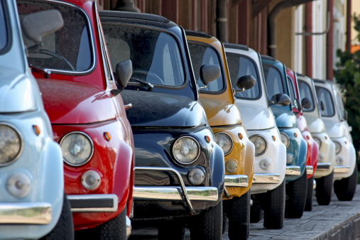 Row of coloured vintage italian cars. They are one of the most popular compact Italian cars produced between '60 and '70.