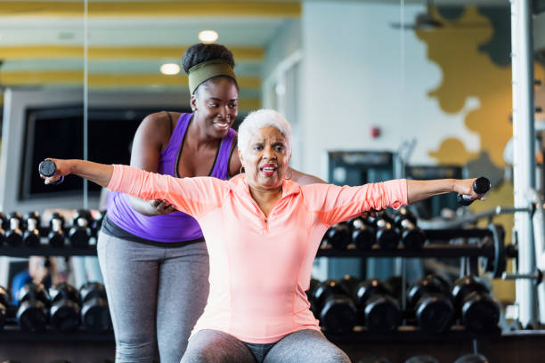 istock Senior woman working out with personal trainer 1172334586