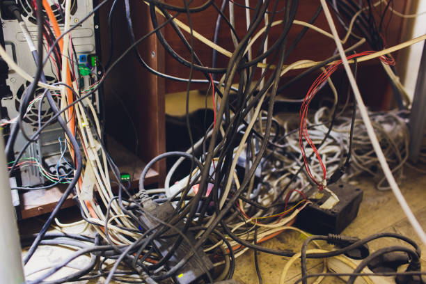 istock Concept of clutter in office. Unwound and tangled electrical wires under the table. 1172334840
