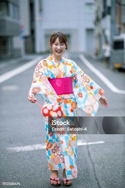 Happy Young Woman In Yukata Standing On Street Stock Photo - Download Image Now - Japan, Japanese Culture, Japanese Ethnicity