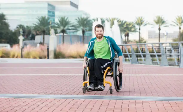 Photo of Man with cerebral palsy in self-propelled wheelchair