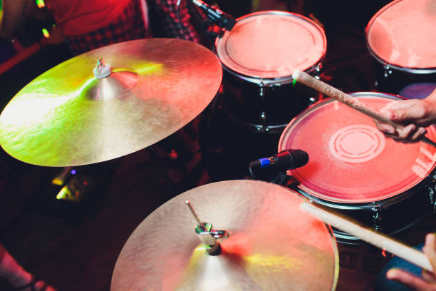 istock Close-up of a male drummer's hand holding drum sticks while sitting behind a drum set. 1172338066