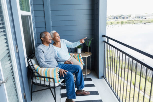 istock Senior couple relaxing on balcony, watching something 1172340113
