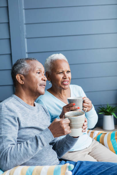 istock Senior couple relaxing on balcony, watching something 1172340118