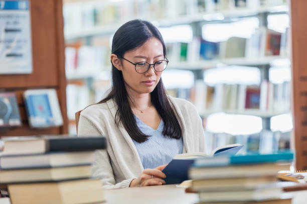 istock Young Asian woman studying in library 1172342553