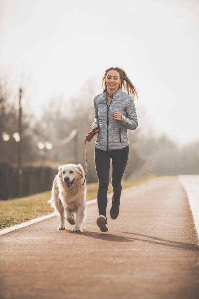 istock Happy woman exercising with her dog 1172343133